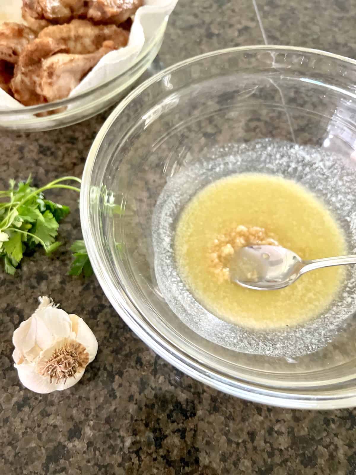 Mixing bowl with melted butter and garlic.