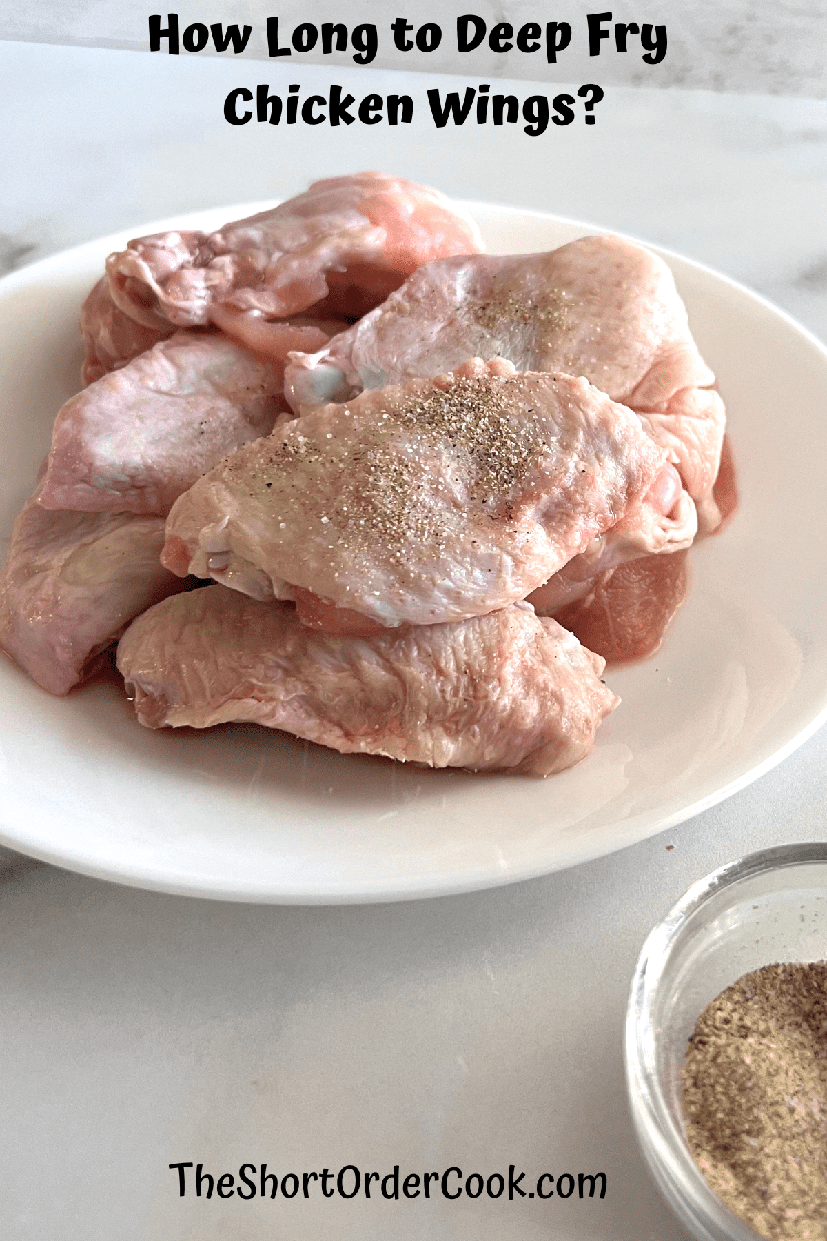 Raw chicken wings plated and ready to deep fry.