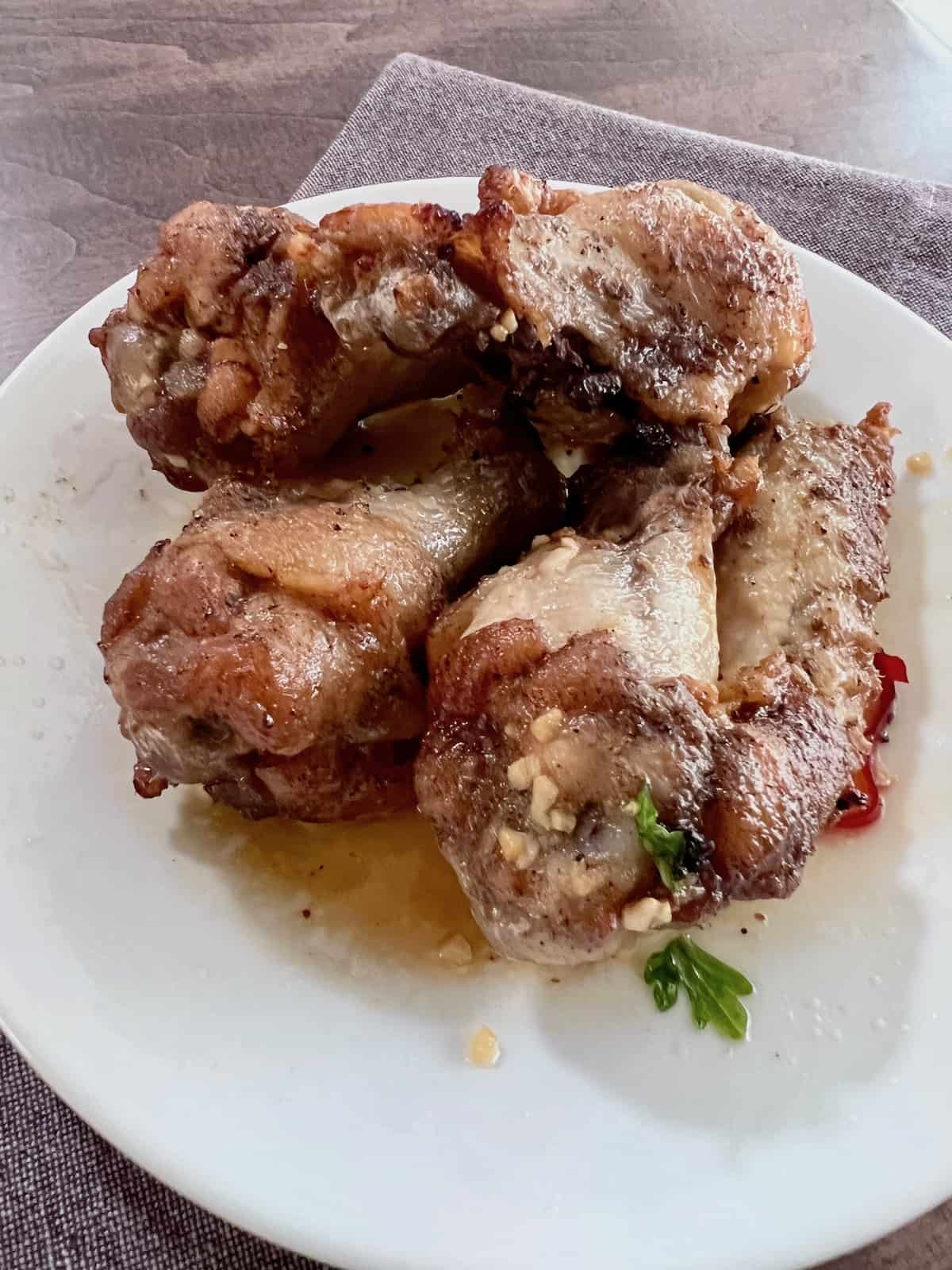 How Long to Deep Fry Chicken Wings? Plated and ready to eat with sauce.