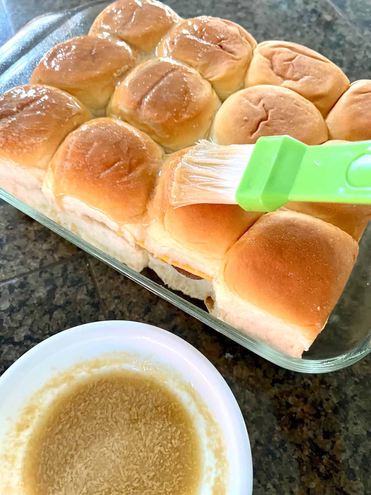 hing the dijon butter sauce on top of the rolls.
