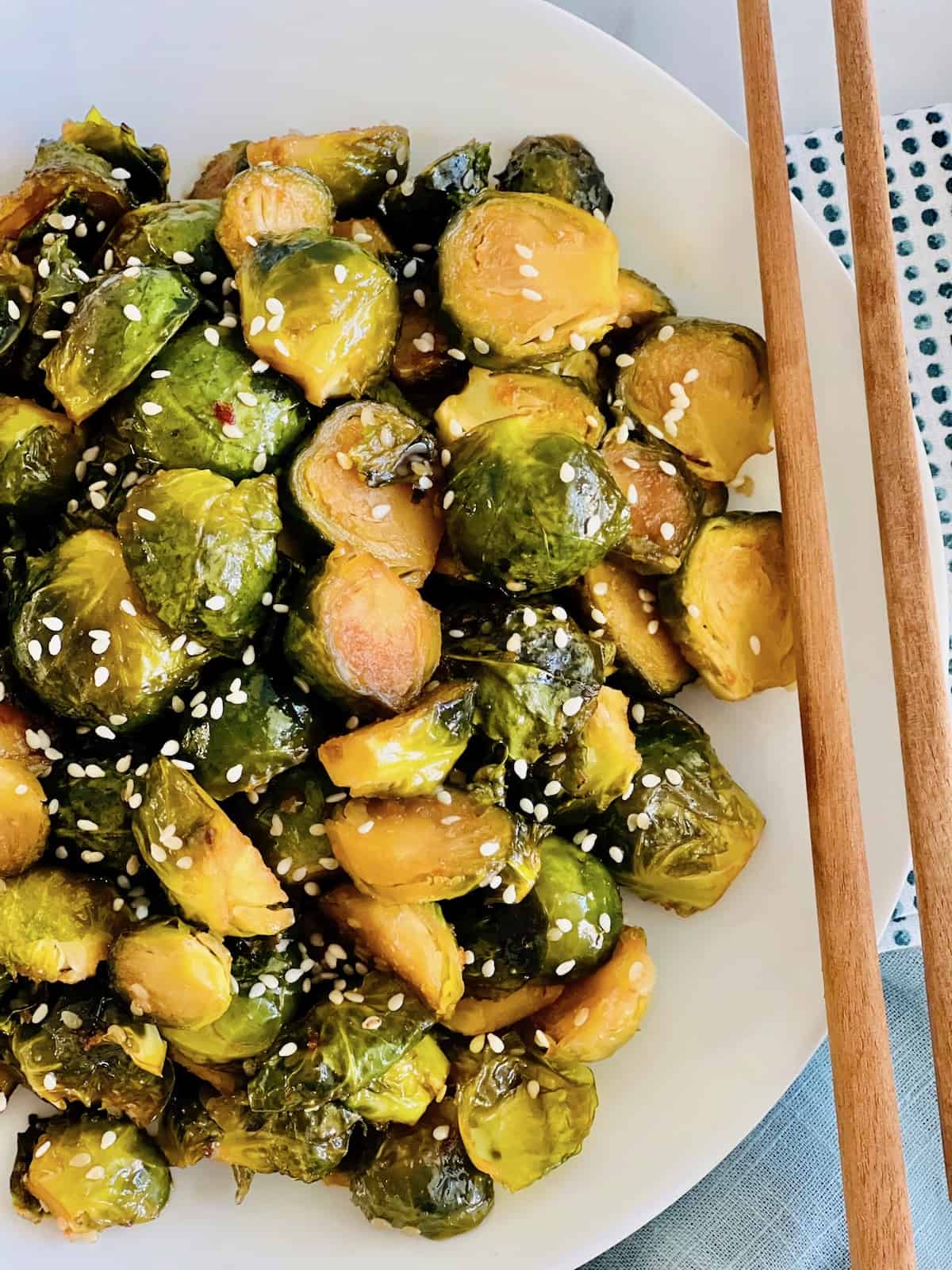 Asian-Inspired Teriyaki Brussels Sprouts Overhead Plated with chopsticks.