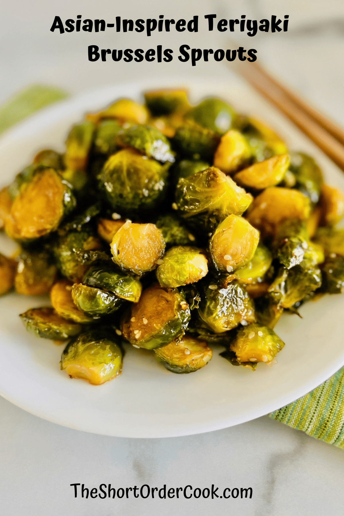 Plate piled high with Brussels sprouts in teriyaki sauce and sesame seeds.