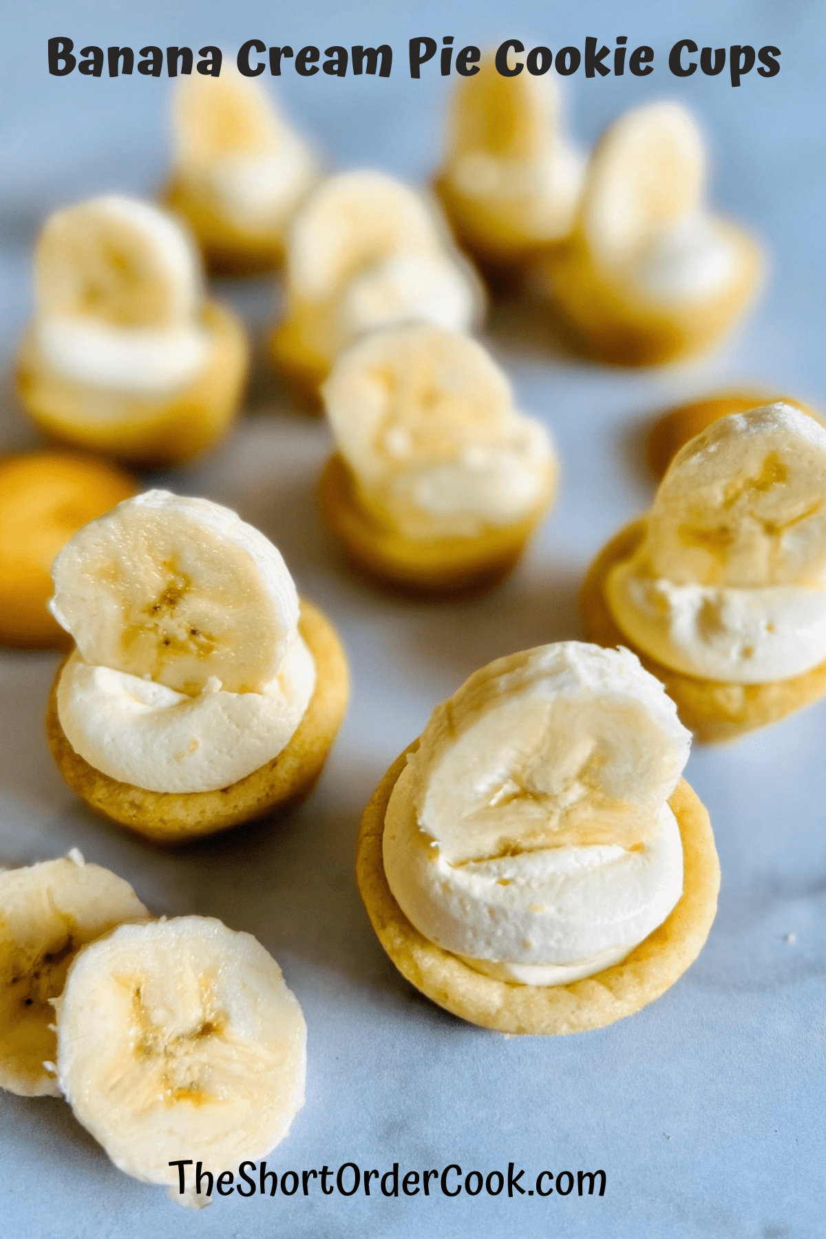 Banana Cream Pie Cookie Cups on a marble counter lined up ready to eat.