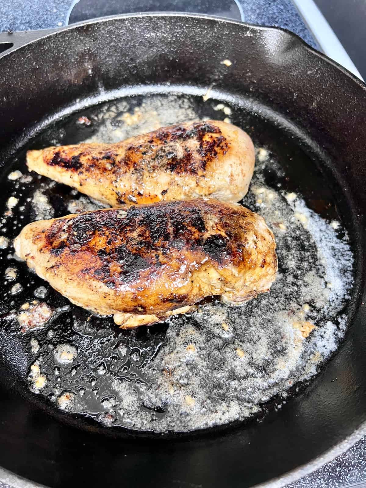 Cast Iron Chicken Breast Add chicken back to the pan with the melted butter and garlic.