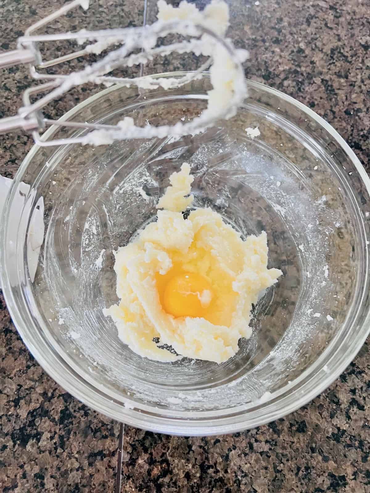 Creamed butter and sugar with egg to make sugar cookie dough.