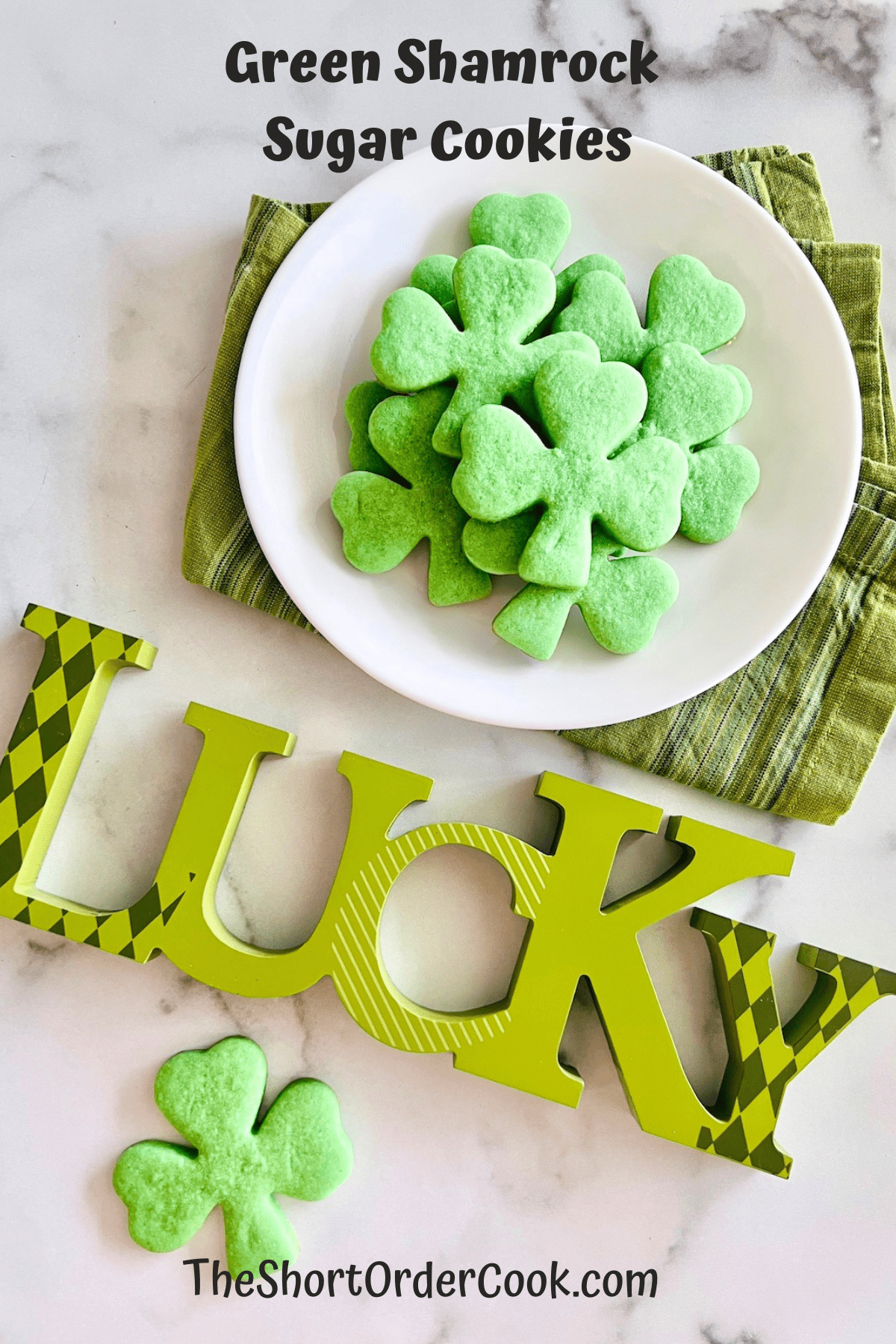 Green Shamrock Sugar Cookies  on a plate ready to eat.