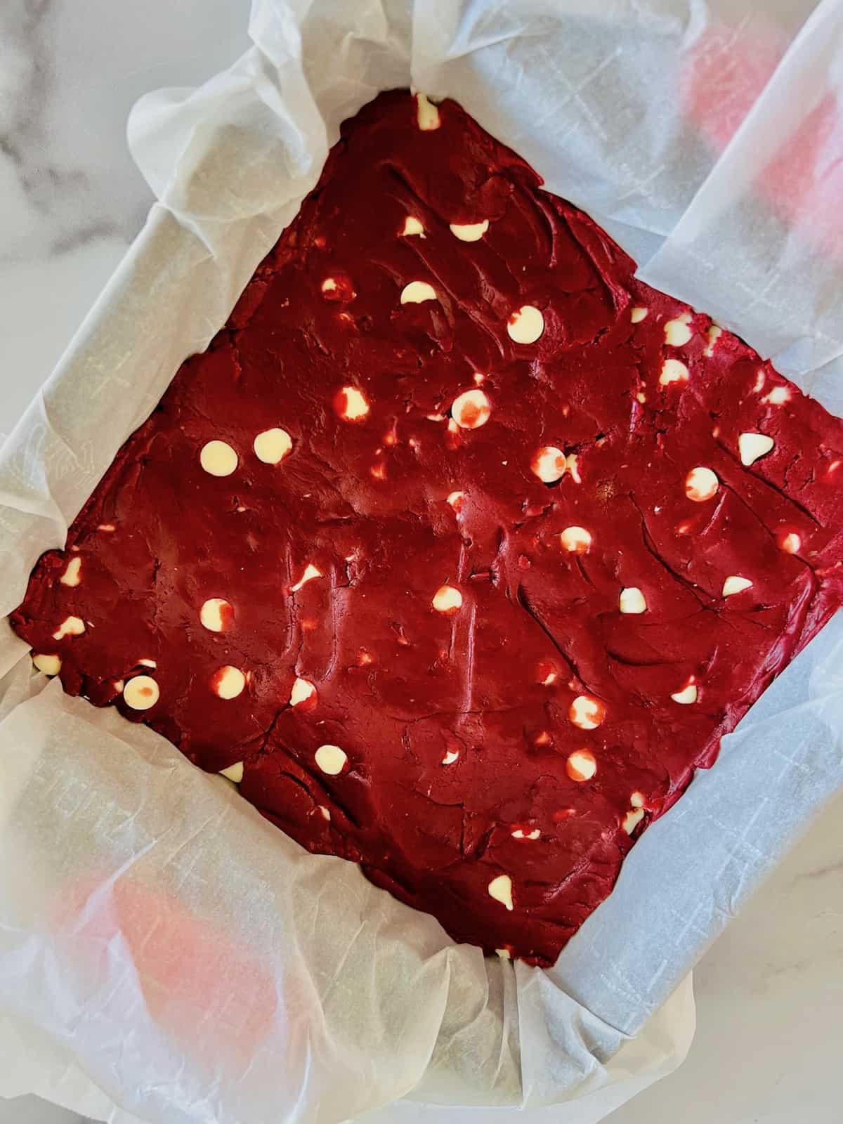 Red Velvet Brownies with Cake Mix Batter spread into the 8x8 pan.