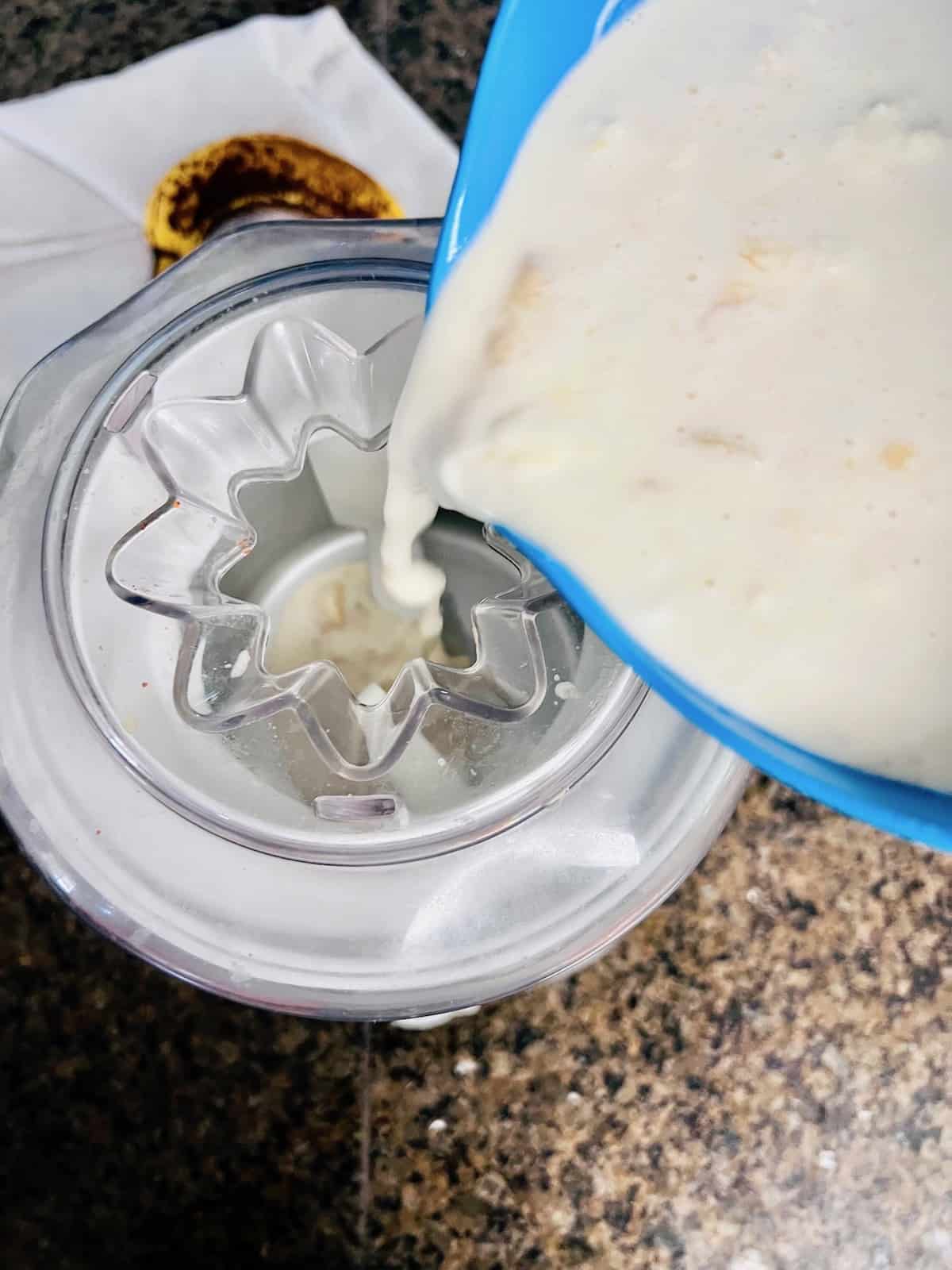 Pouring the cold mixture into the ice cream maker.