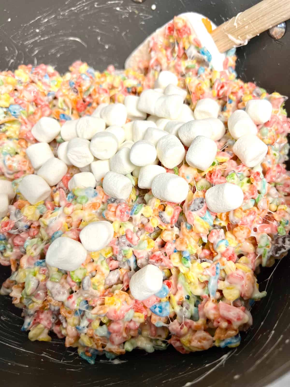 adding mini marshmallows to the mixture.