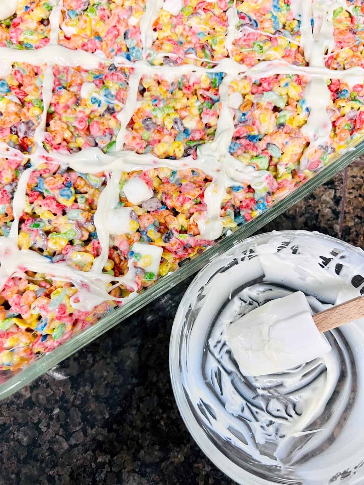 Fruity Pebbles Cereal Bars Drizzling the bars with white candy melts.