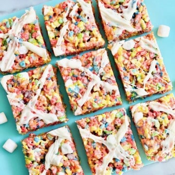 Fruity Pebble colorful squares cut and topped with candy melt drizzle.