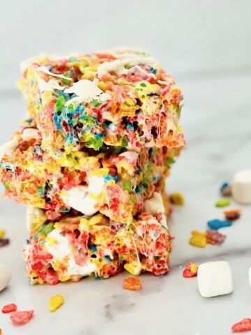 Fruity Pebbles Cereal Bars cut into squares and 3 stacked up.