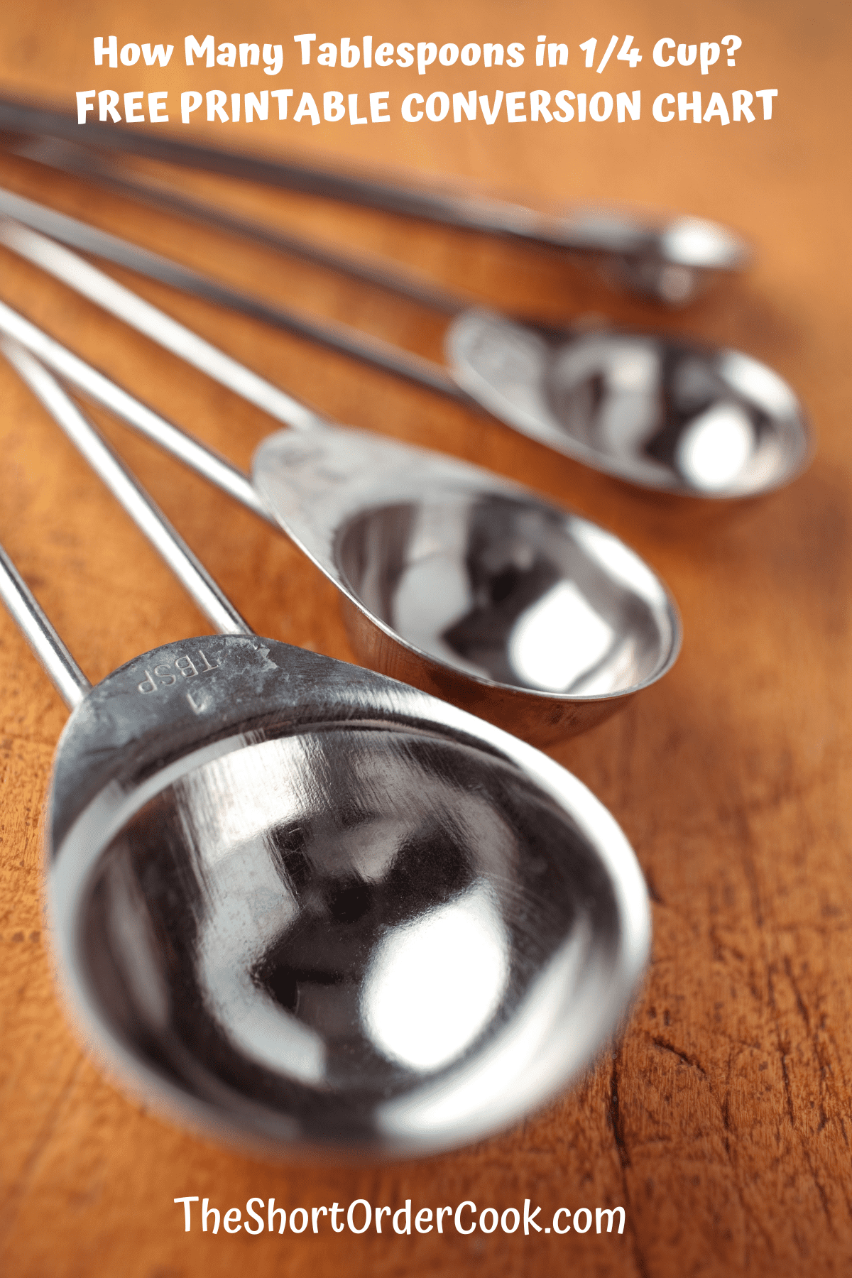 Metal spoons on a wood table.