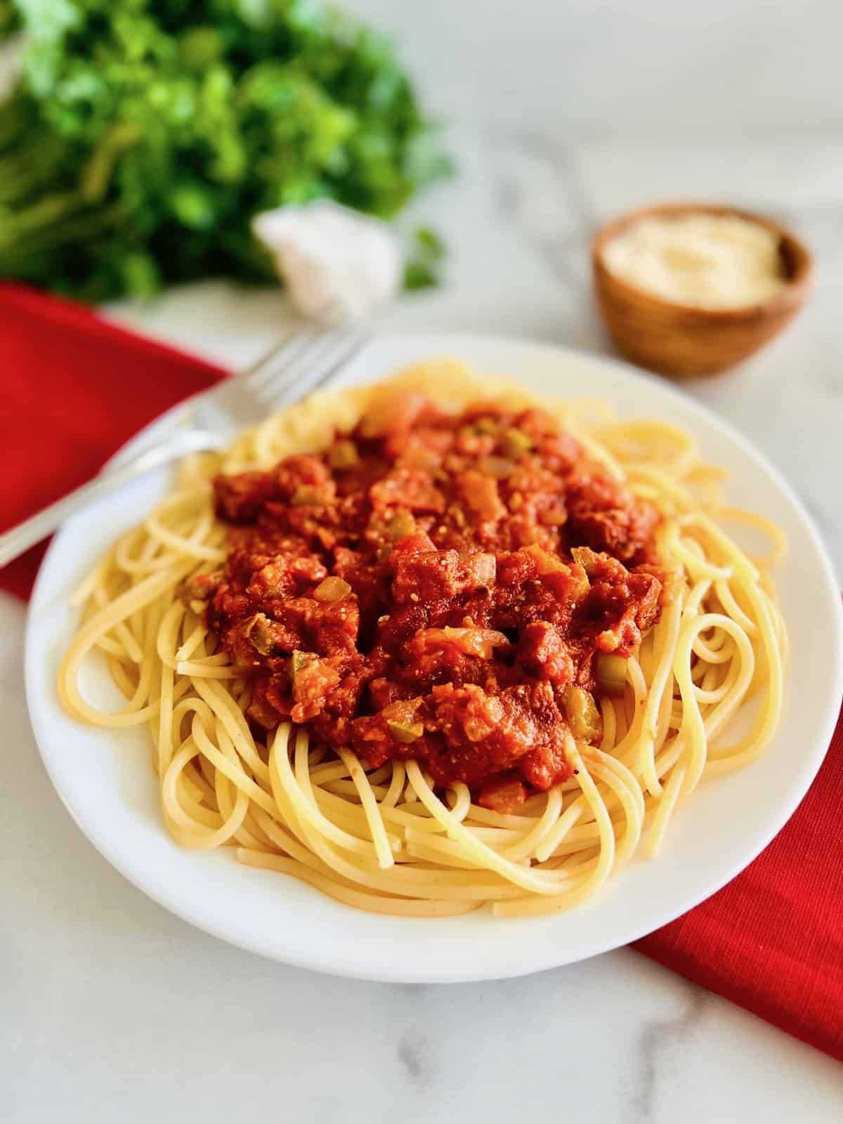 Pepperoni Spaghetti Plated and ready to top with parsley and cheese.