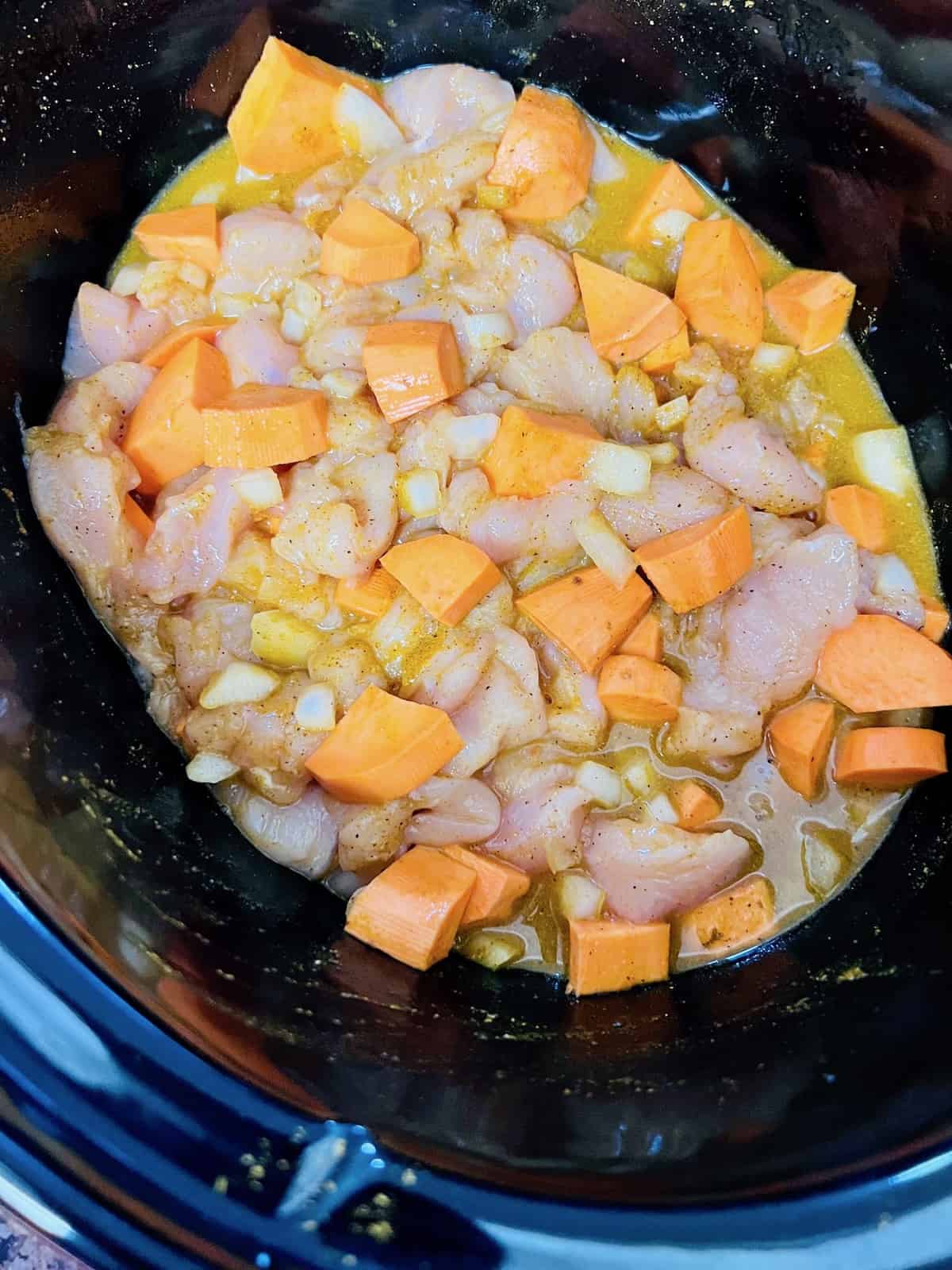 Slow Cooker Chicken & Sweet Potato Curry All ingredients in the crockpot ready to cook.