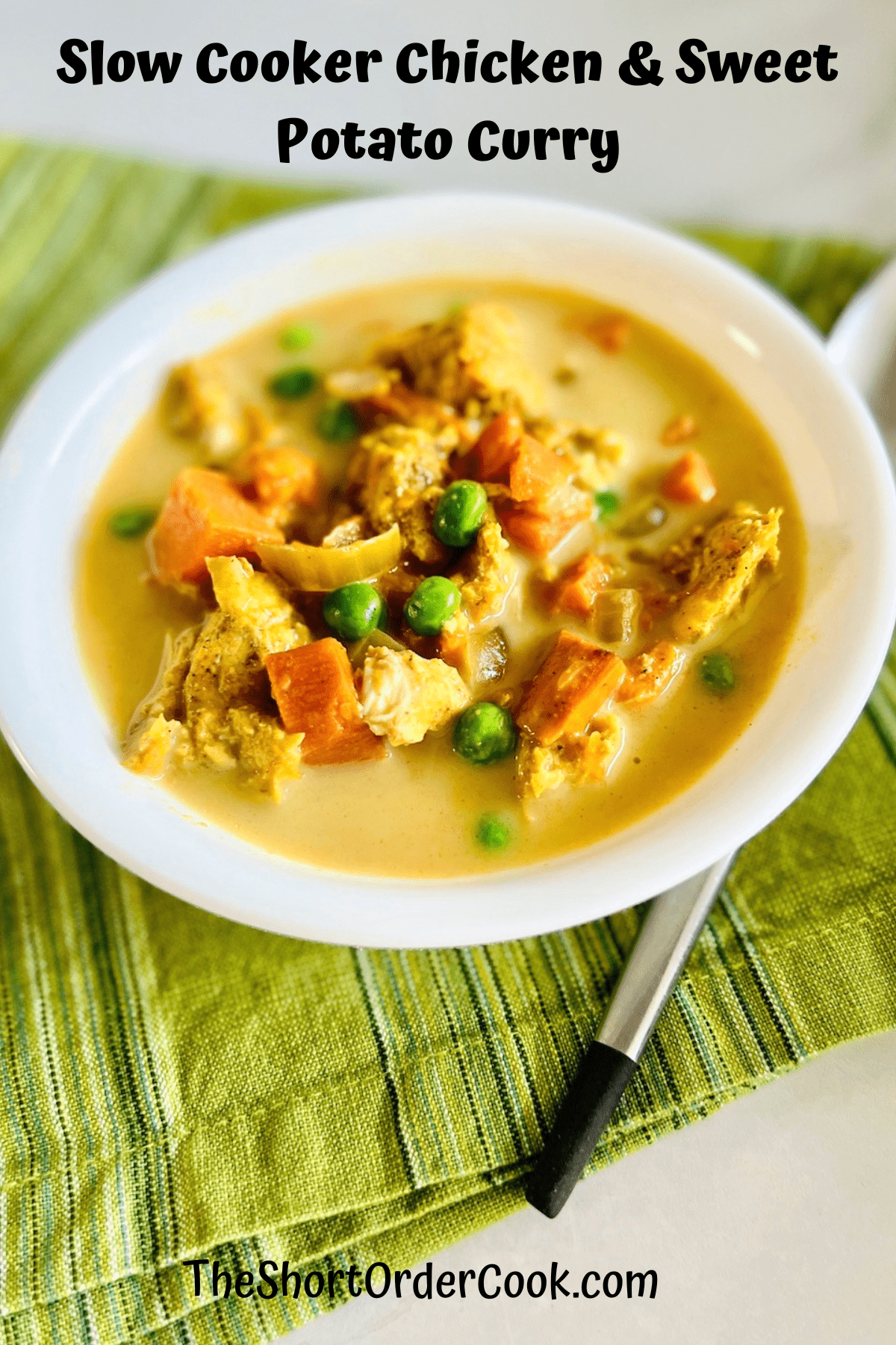 White bowl filled with golden colored red Indian curry chicken with sweet potatoes.