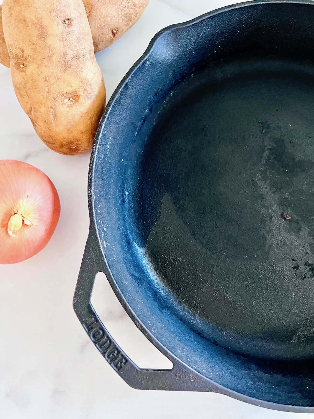 Pan Fried Potatoes & Onions Ingredients and cast iron skillet.