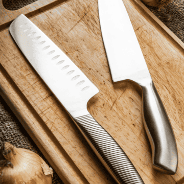 Two chef's knives sitting on a wooden block priced under $100 to buy.