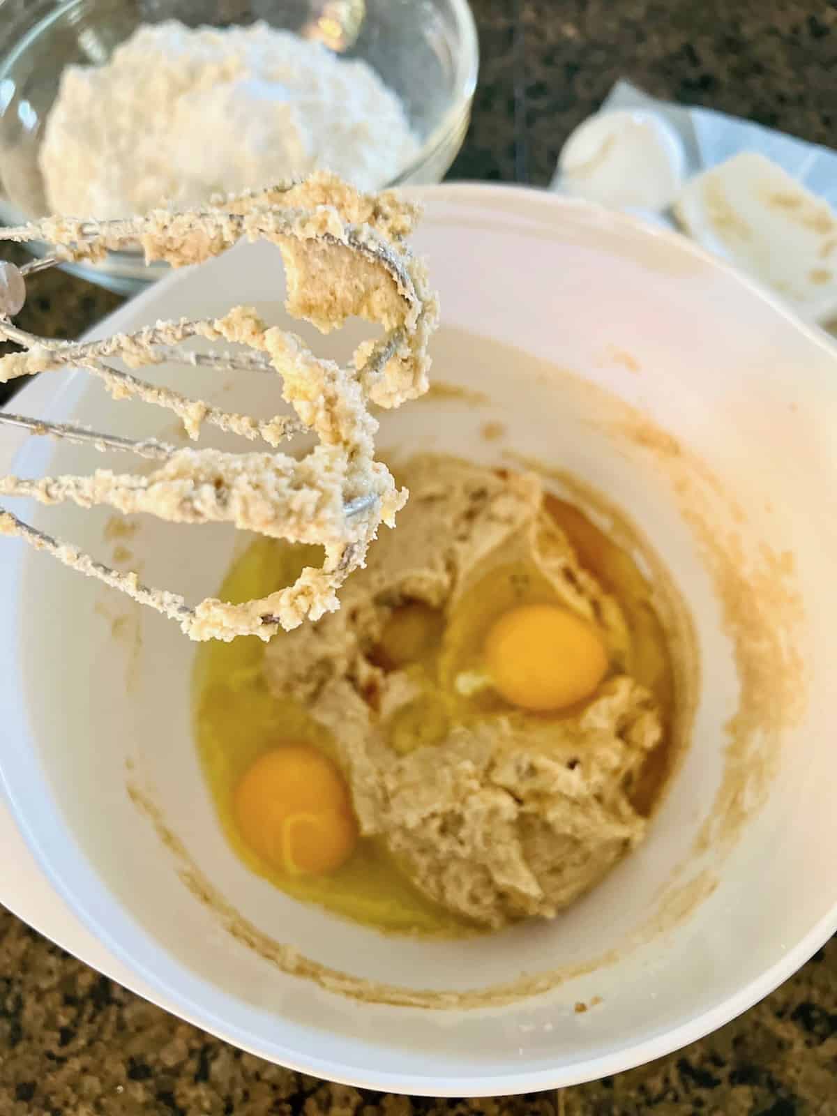 Adding eggs to creamed sugar.