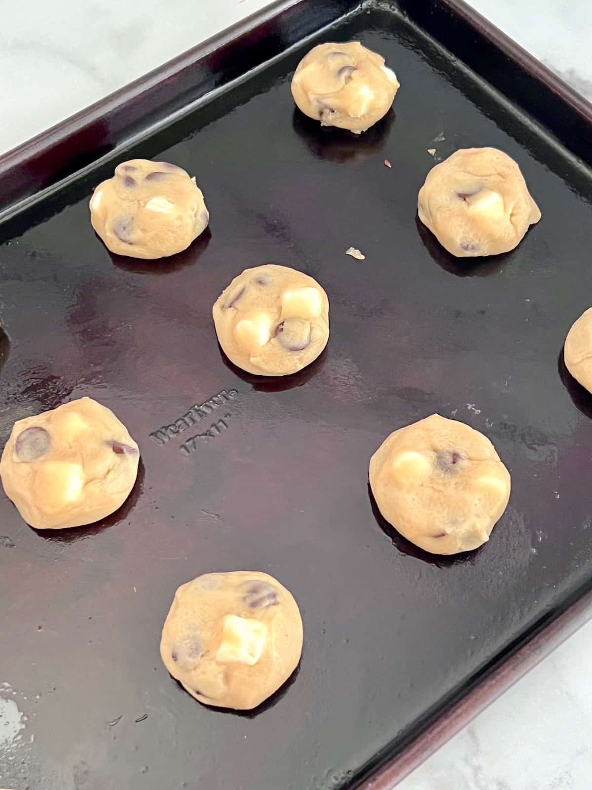 Chocolate Chip Marshmallow Cookies Rolled cookie dough balls on the baking sheet.