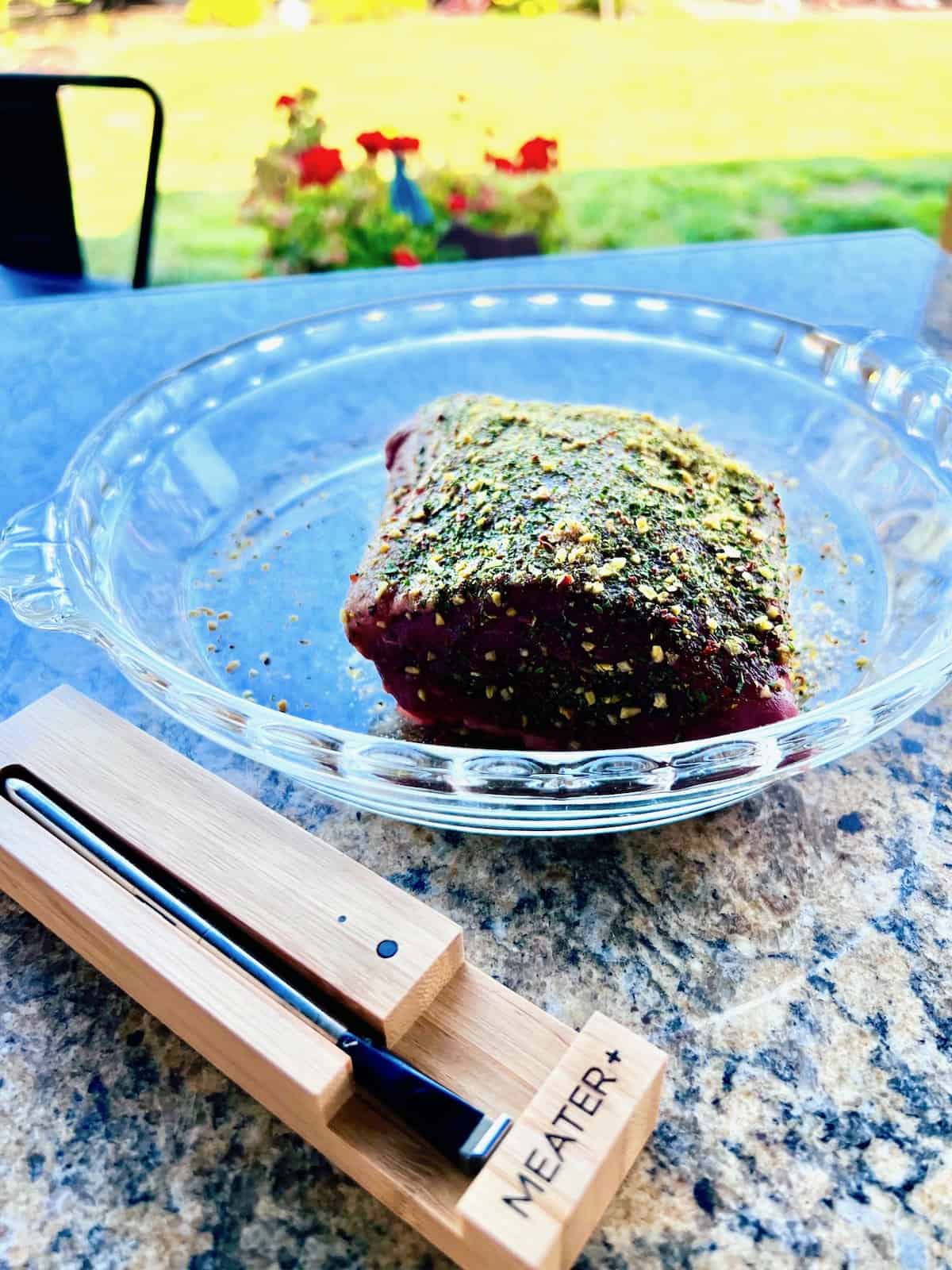 Grilled Tri-Tip Ready with a rub on it & in a dish next to the Meater temperature probe.