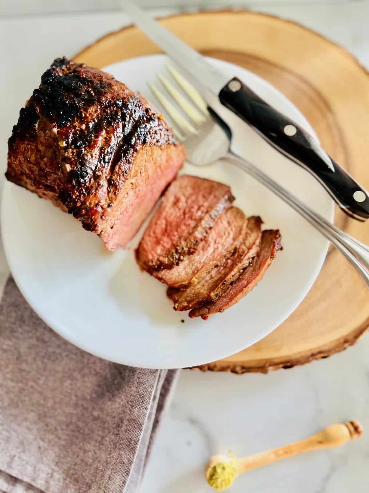 Tri-Tip roast plated, showing how to slice the meat against the grain.