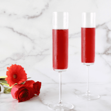 Pomegranate mimosas in two glasses.