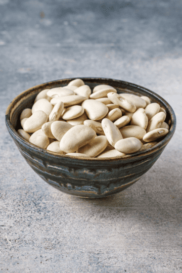 a bowl of dried white lima beans.