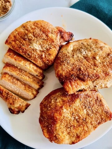 Plated thick pork chops cooked in the air fryer.