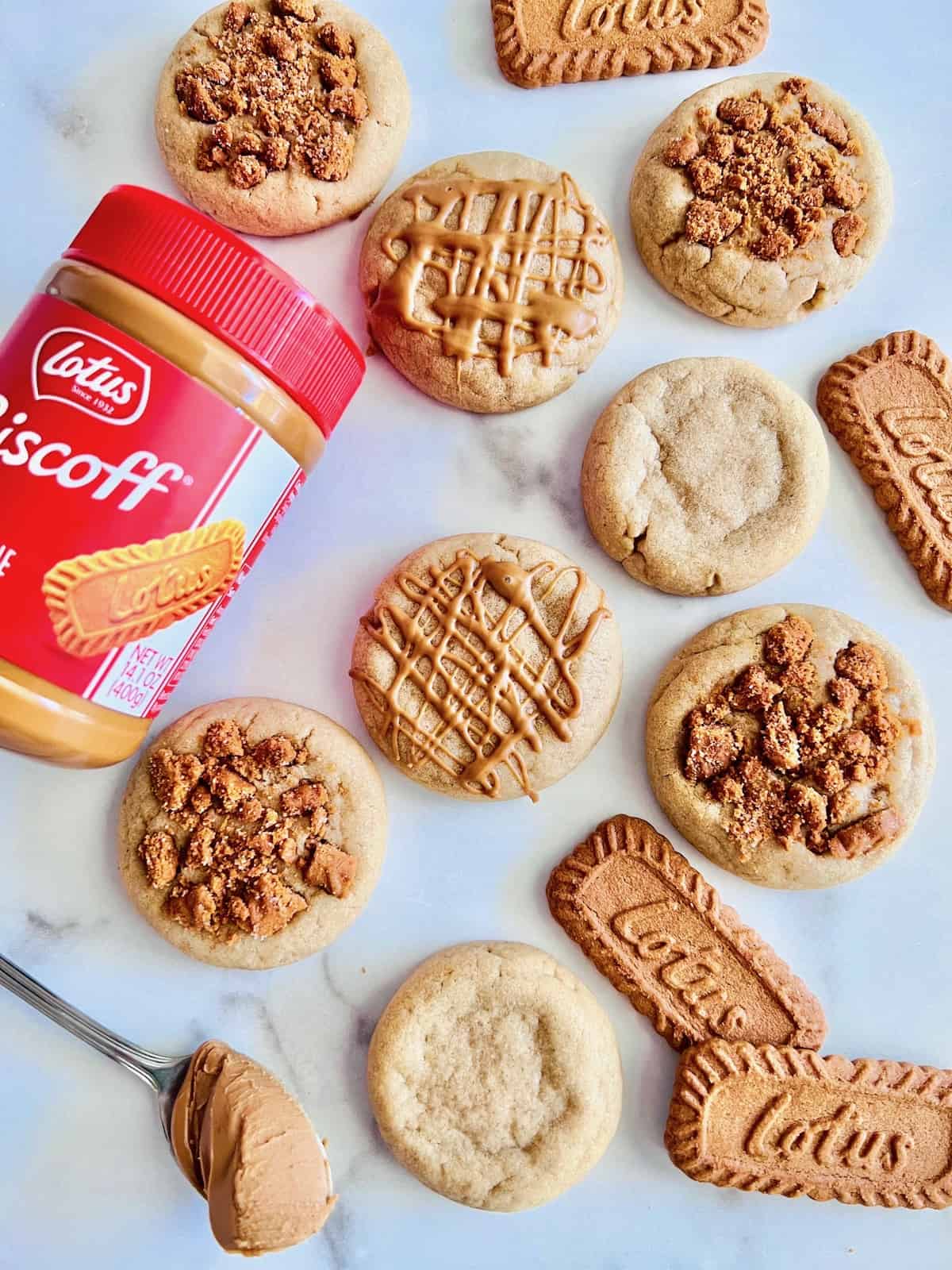 Biscoff Butter Cookies on marble counter with jar of Biscoff cookie butter lotus cookies and a spoon with cookie butter.