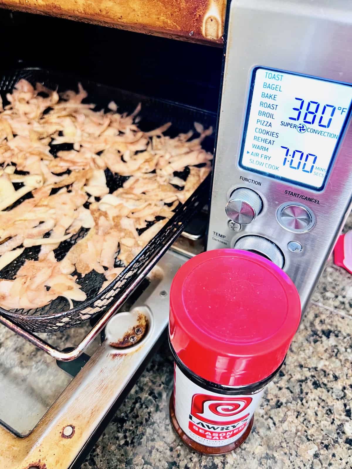Crispy Air Fryer Potato Peels in the air fryer on the tray to cook.