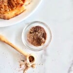 Pork chops plated next to a dry rub made homemade from the best recipe.