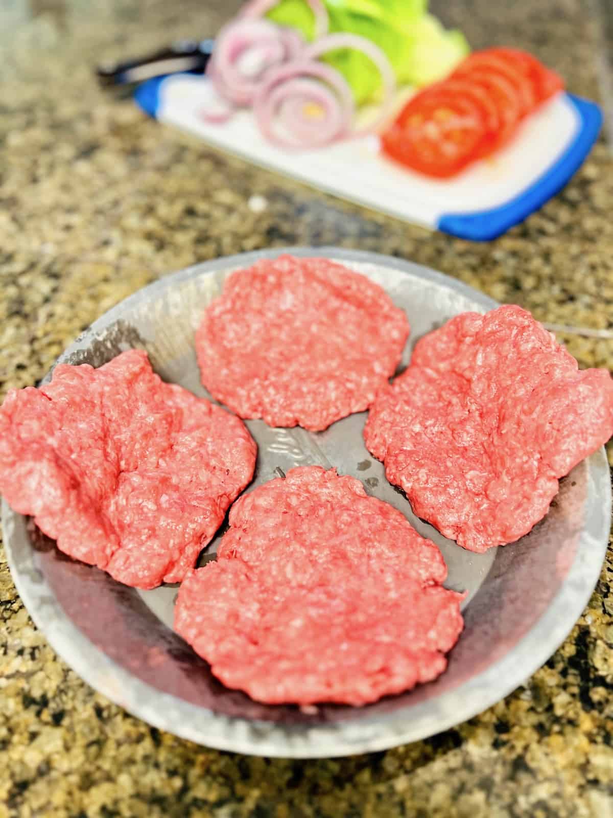 Wagyu Burgers Patties on a pan ready to cook.