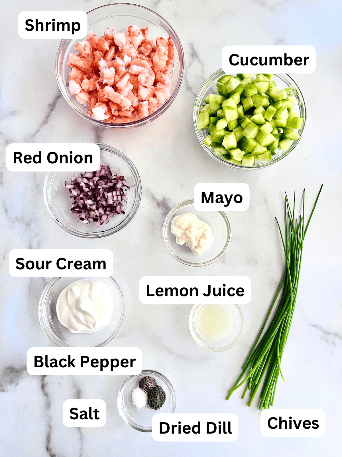 Cucumber Shrimp Salad Ingredients in bowls on a table.