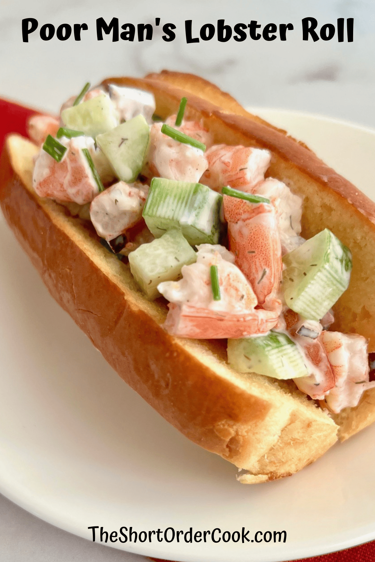 Poor Man's Lobster salad in a mayo dressing plated in a roll.