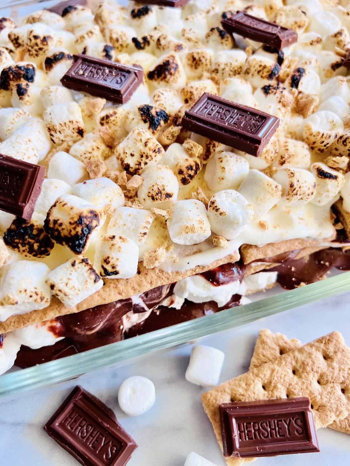 S’mores Icebox Cake with layers of chocolate pudding graham crackers and marshmallow cream.