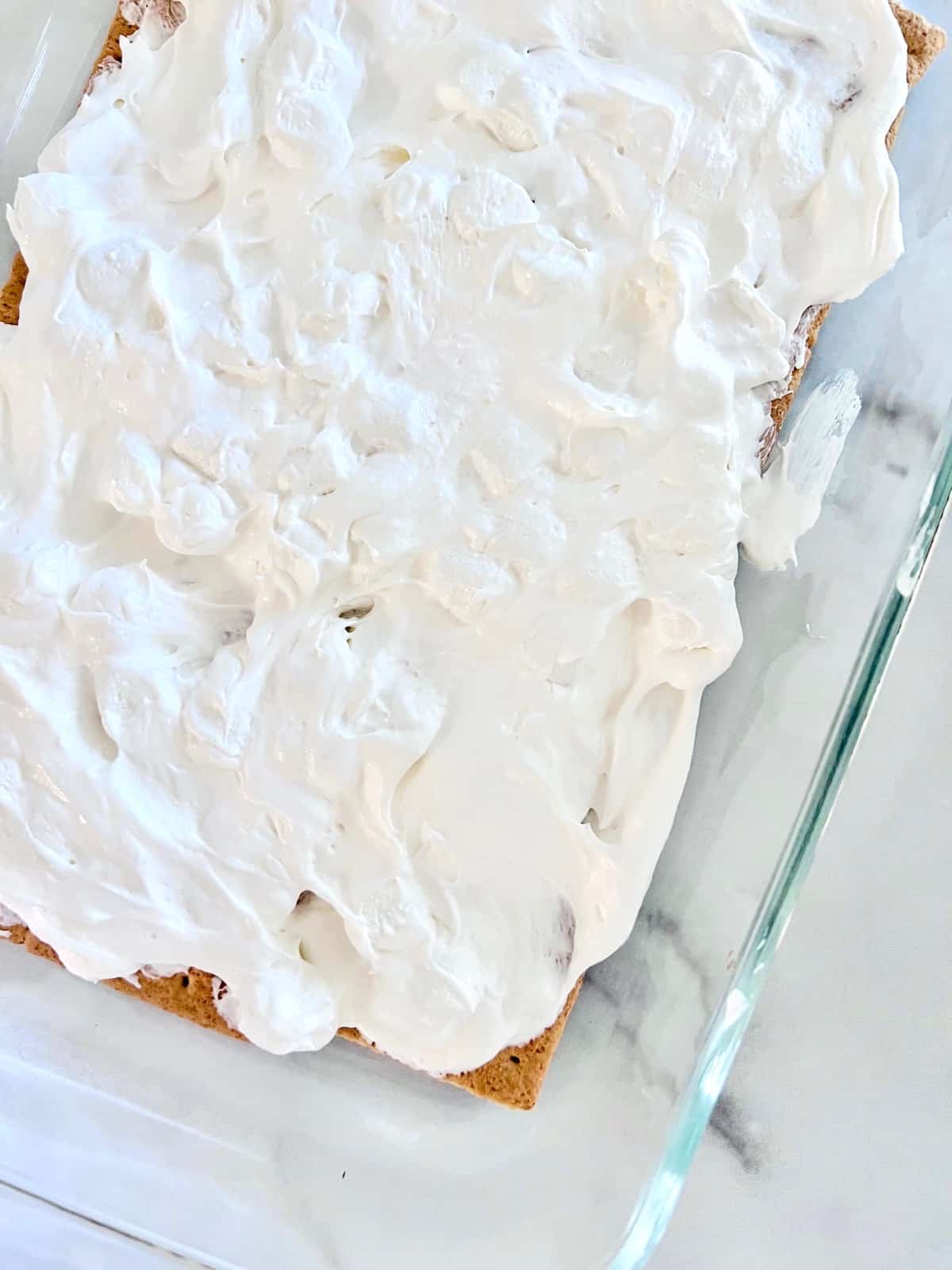 Marshmallow cream layer on top of graham crackers.