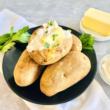 Air Fryer Baked Potatoes with toppings on a plate.