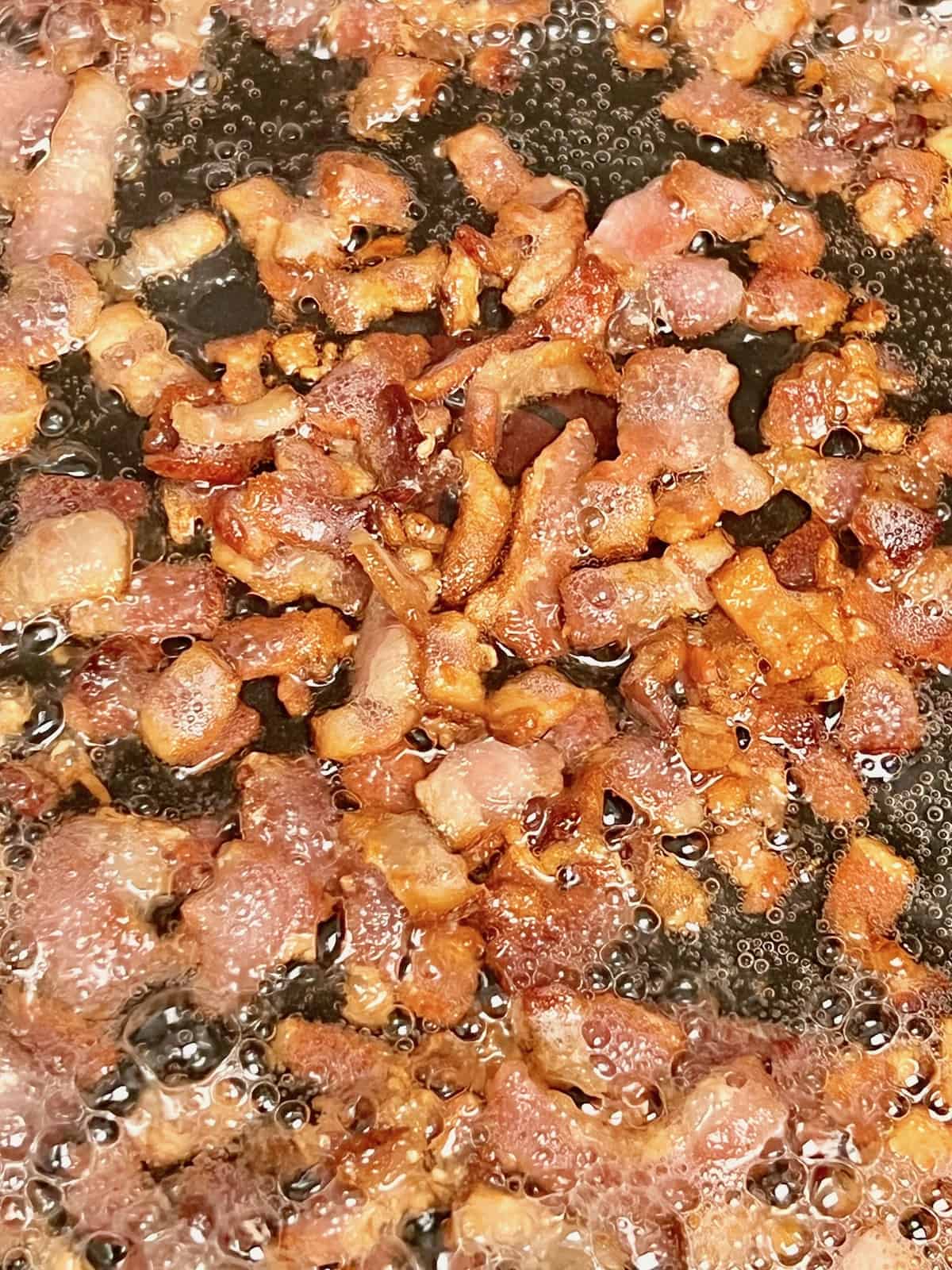 Bacon fried up in the pan.