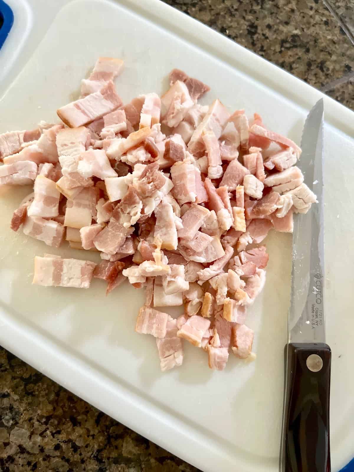 Diced up bacon on a cutting board.