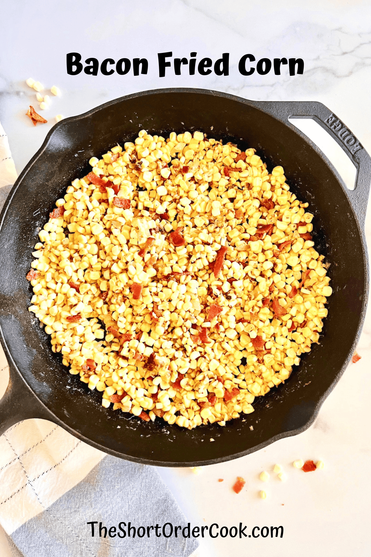 Bacon fried corn in a cast iron skillet.