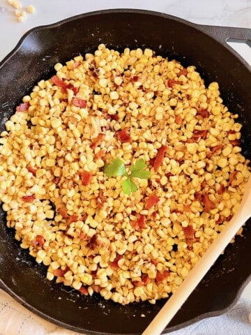 Southern cooked Bacon Fried Corn ready in a cast iron skillet.