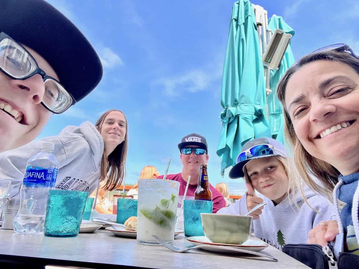 Family at the table ready to eat at a restaurant on the water at Friday Harbor.