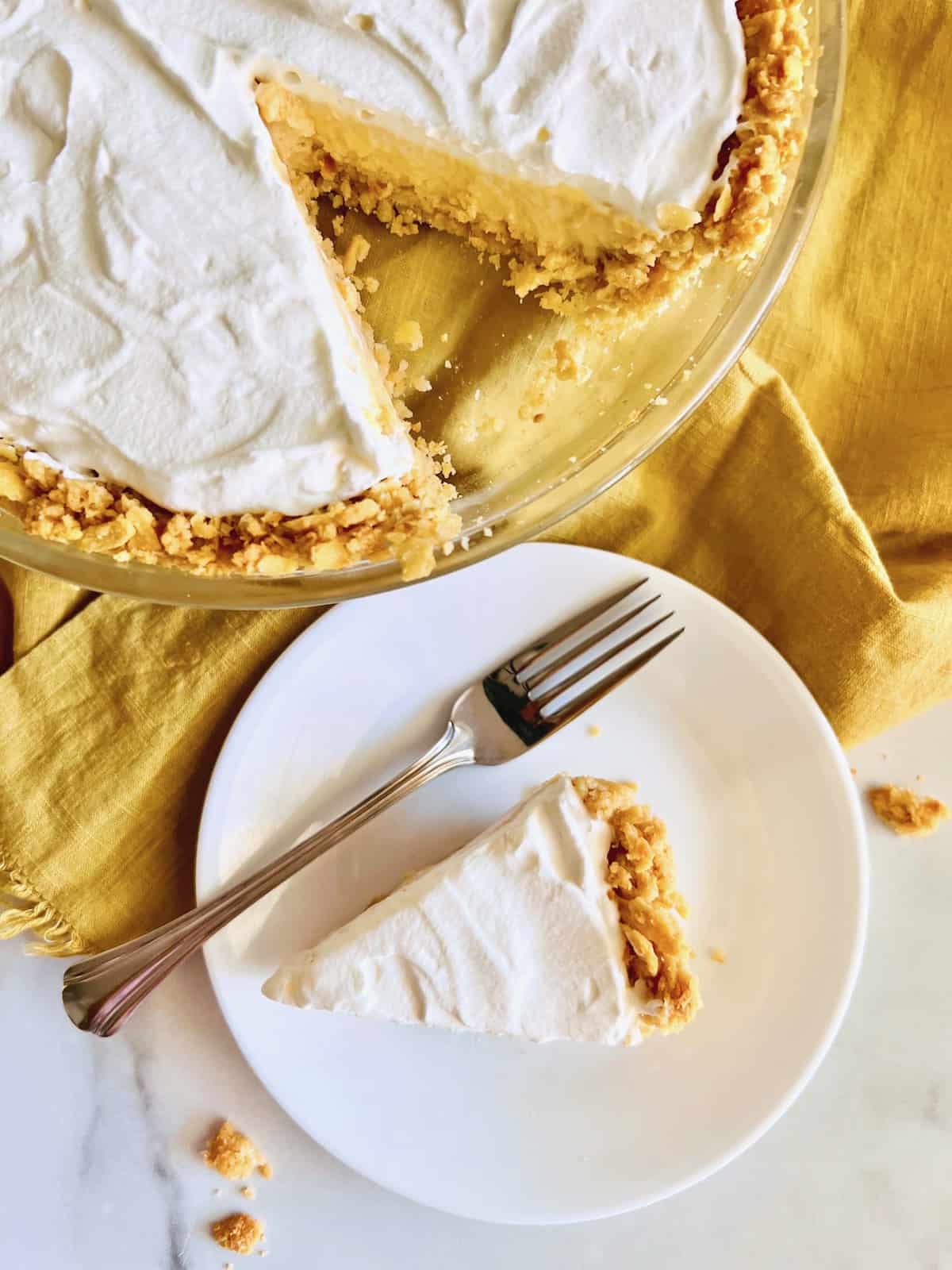 North Carolina Lemon Pie Plated slice and full pie with cut overhead,