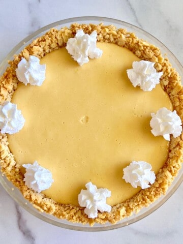 North Carolina Lemon Pie featured with dollops of whipped cream atop lemon curd filling & a saltine cracker crust.