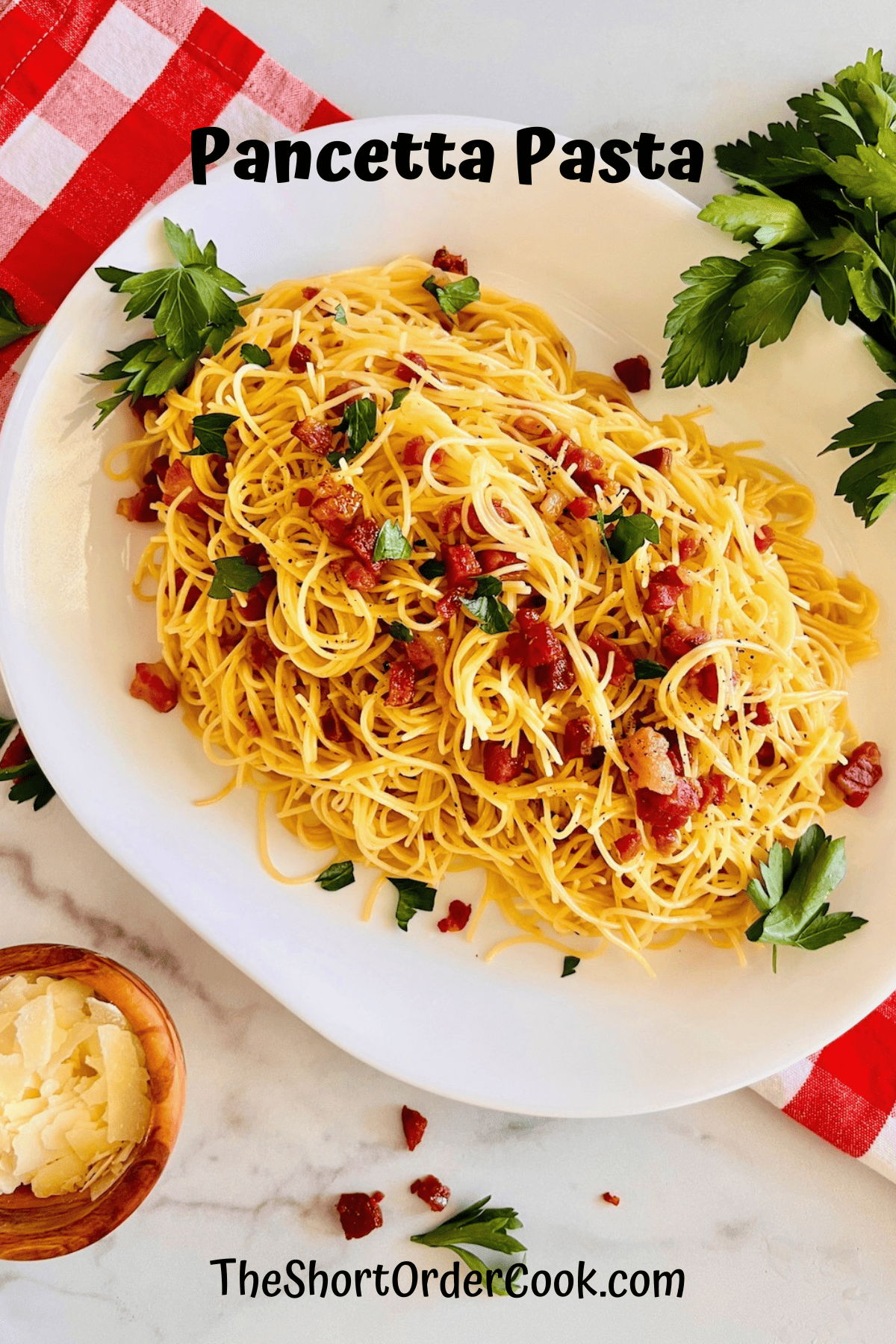 Platter of angel hair pasta with crispy pancetta, parmesan, butter, and garlic.