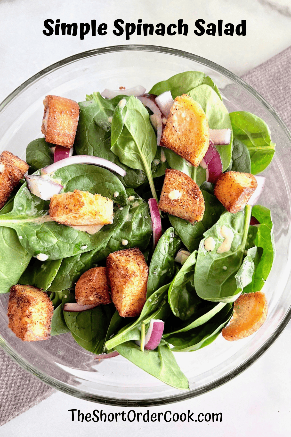 Simple Spinach Salad in a serving bowl ready to plate & eat.