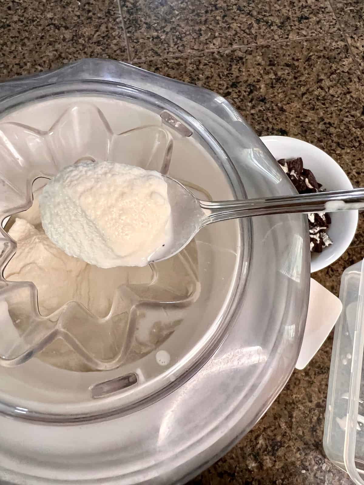 Oreo Cookies & Cream Ice Cream Spoon scooping freshly churned ice cream from the maker.