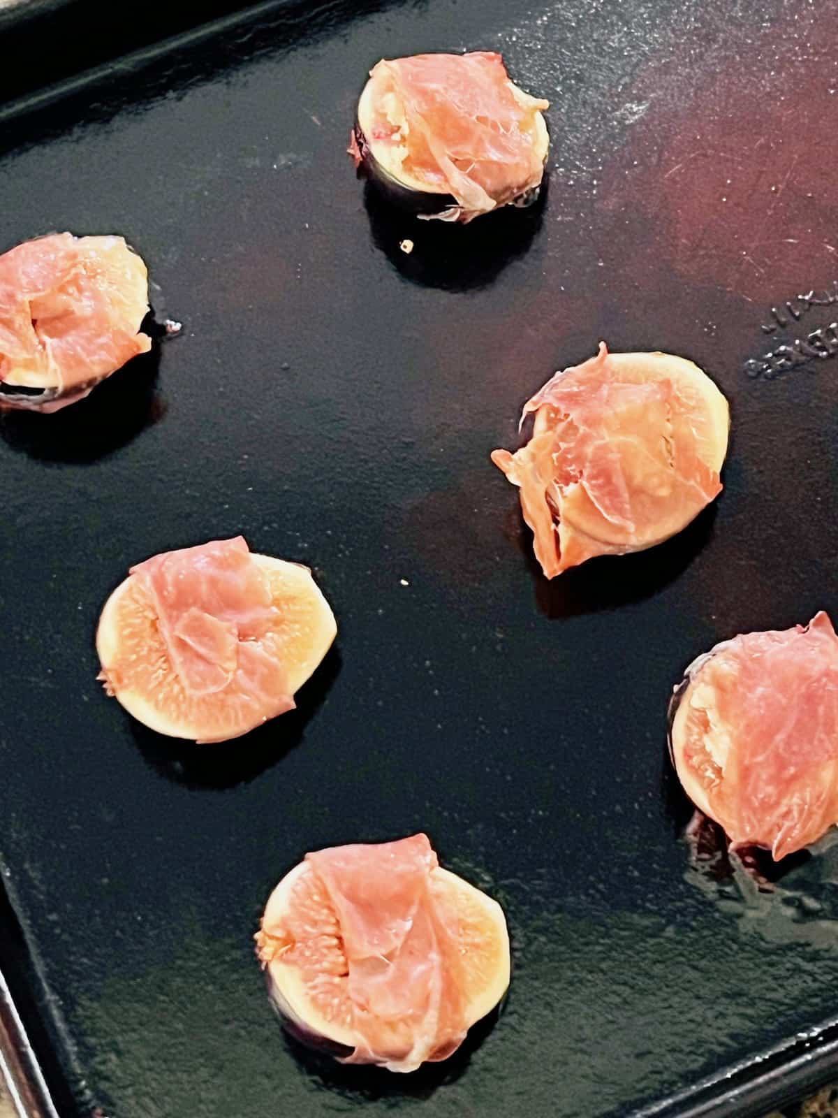 Roasted Prosciutto-Wrapped Figs Ready on a baking sheet.