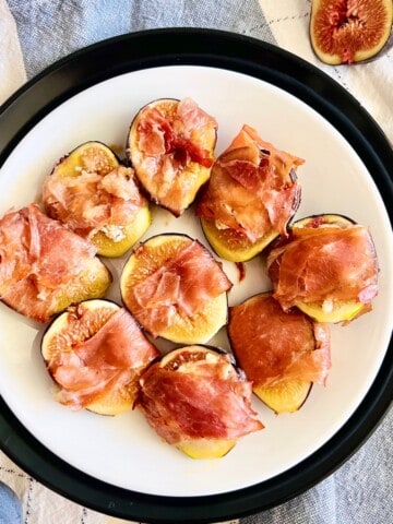 Roasted Prosciutto-Wrapped Figs featured with napkin.
